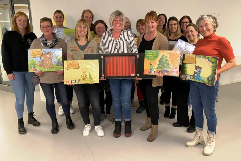 Sprachförderung bei den Kleinsten. Zwölf Tageseltern freuten sich am Einführungsabend über den Erhalt von Kamishibais und Bildkarten-Sets. In der Mitte Sabine Deppenmeier vom Buchhaus am Markt in Detmold mit dem Kamishibai in den Händen, rechts daneben Projektleiterin Marie-Theres Horowski von der Stiftung „Für Lippe“. Zwei Tagesmütter fehlten krankheitsbedingt. Sie haben ihre Erzähltheater zwischenzeitlich bereits im Buch Haus am Markt in Detmold abgeholt. Fotoquelle: Kreis Lippe