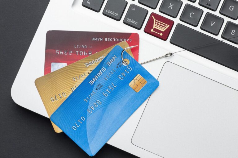 top view laptop with credit card phishing hook. High resolution photo