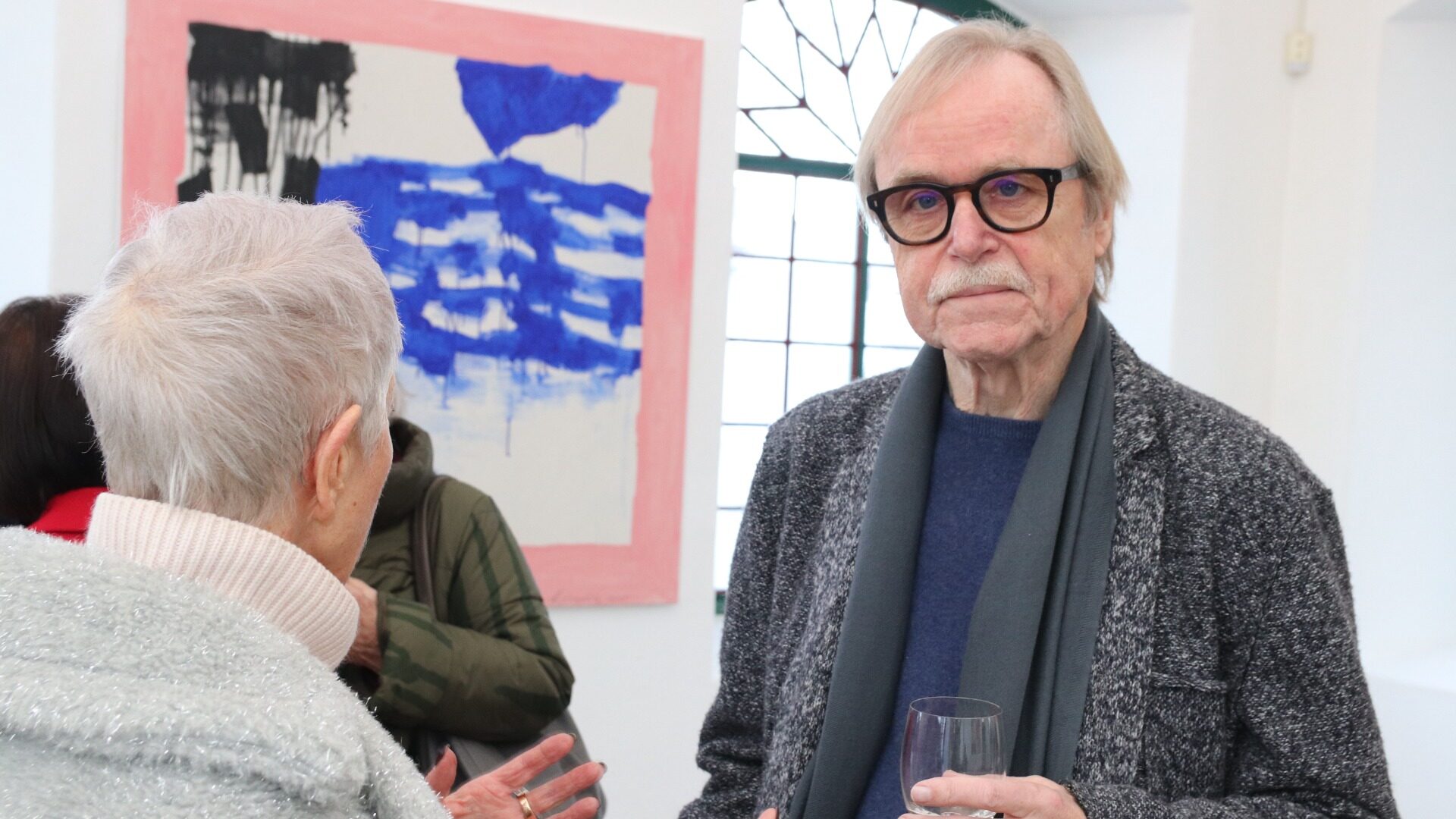 Wolfgang Troschke (hier im Gespräch mit einer Besucherin) gilt als ein virtuoser Meister sämtlicher grafischer Drucktechniken, die er miteinander und mit seiner Malerei kombiniert.  Foto: kd