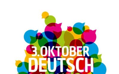 Weißer Schriftzug 3. Oktober Deutschland singt und klingt auf vielen bunten Sprechblasen als Umriss Deutschlands